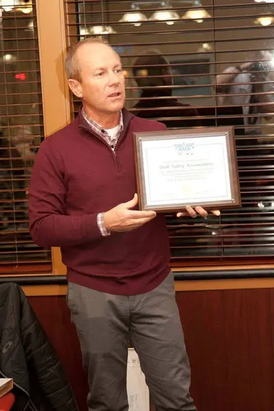Darin shows the plaque for UVA's new AMA "Gold Leader Club" status.
